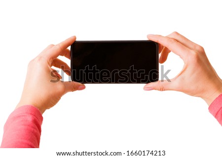 Person holding in hands smartphone and taking picture or recording video, photo isolated on white background