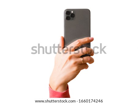 Person holding in hand mobile phone with triple lens camera, photo isolated on white background