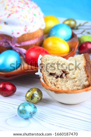 Easter bread and colorful eggs on a wooden, white background. Easter background. 