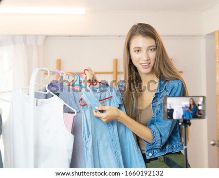 women blogger video blog youtuber reviewing shirt video live Streaming to social network by internet at home, beauty blogger concept  SME shop