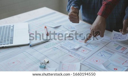Designers man drawing (UX) (UI) Graphic designer creative sketch planning application process development prototype for responsive web desig Royalty-Free Stock Photo #1660194550
