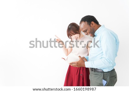 Young woman teaching way for foreign tourist