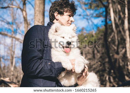 Man playing with the dog in the countryside