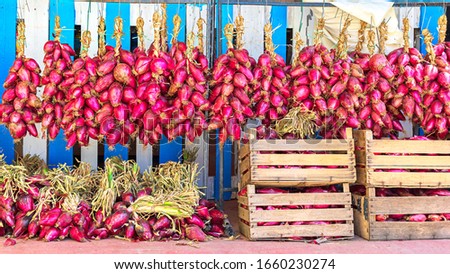 Tropea sweet red onion on display for sale in local market – world food concept with boxes full of bio onions from eco farming Royalty-Free Stock Photo #1660230274