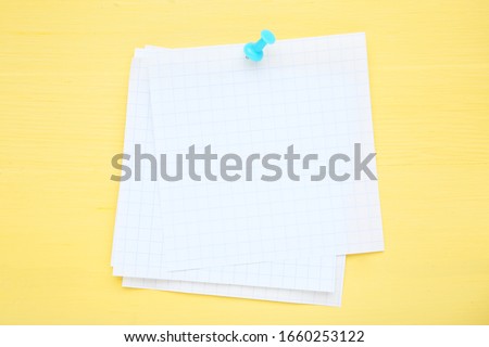 Paper sticky note on yellow wooden table