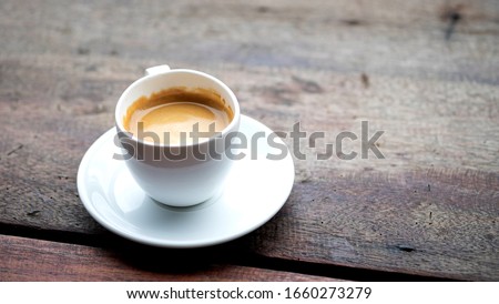 Hot capucino coffee cup on the wooden table