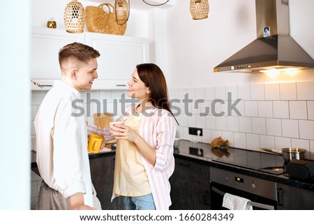 loving couple enjoying spending time in the kitchen, close up side view photo.interest, care , friendsip, woman gives advice to her friend , copy space