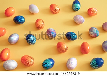 Easter colored eggs on a colored background. Easter background with lots of eggs. The concept of the Easter holidays.