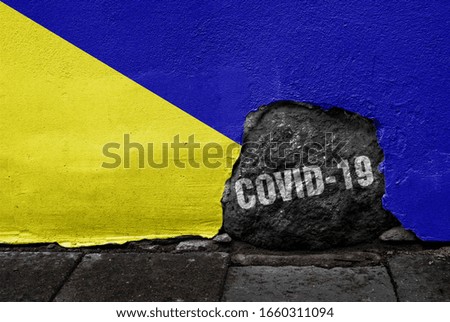 Flag of Holdenville on the wall with cracked stone with Coronavirus name on it. 2019 - 2020 Novel Coronavirus (2019-nCoV) concept, for an outbreak occurs in Holdenville, Oklahoma.