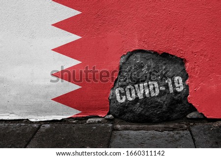 Flag of Bahrain on the wall with cracked stone with Coronavirus name on it. 2019 - 2020 Novel Coronavirus (2019-nCoV) concept, for an outbreak occurs in Bahrain.