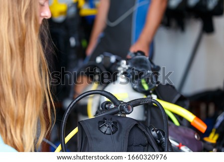 driver prepares the equipment for the dive. Equips the oxygen tank, close-up, depth of field.