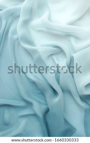 Silk fabric texture background pastel blue color. Beautiful soft crumpled backdrop.Copy space