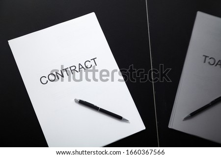 Transparent contract. A contract printed on paper and a pen lies in a glass box close-up

