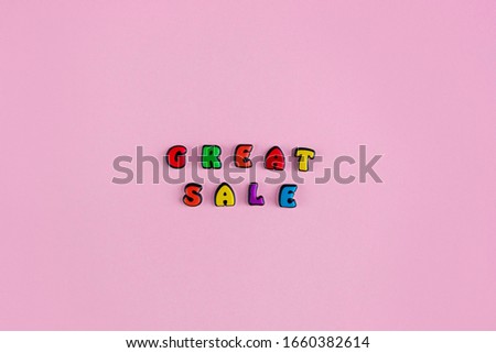 Inscription Great Sale composed of colored letters on a pink background. Discount and advertisement. Seasonal sale in stores. The photo for a banner or poster on the site and on social networks