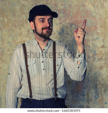 Excited man pointing a great idea adjusting his suspenders