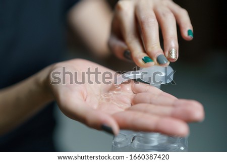 hands using wash hand sanitizer gel pump dispenser. Clear sanitizer in pump bottle, for killing germs, bacteria and virus. Royalty-Free Stock Photo #1660387420