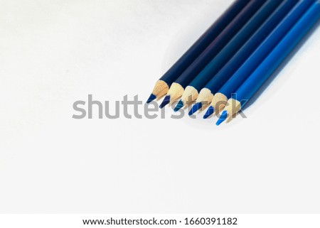 The set of colored blue and dark blue pencil in raw on white background