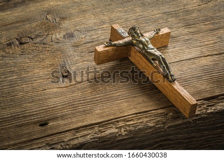 Jesus Christ crucified n wooden background.Easter concept.