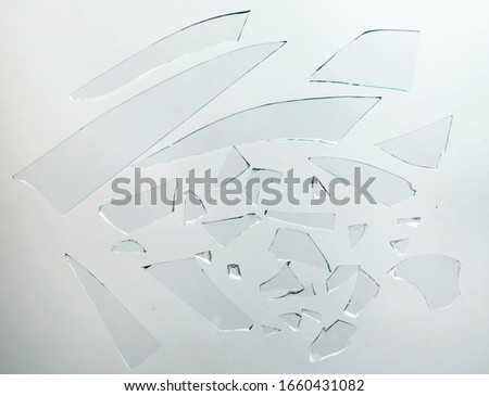 Small pieces of broken glass on a white surface