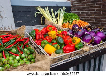Fresh vegetables on display at an open air market.