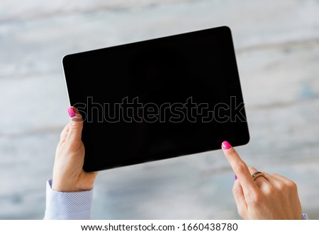 Person using tablet computer, screen mockup