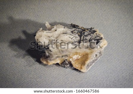 Close-up of Sharp-Looking Antimonite Mineral Placed on Gray Paper Background