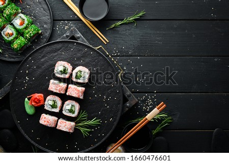 Japanese sushi with crab sticks, cheese, onion and cucumber. Asian Diet Food. Top view.