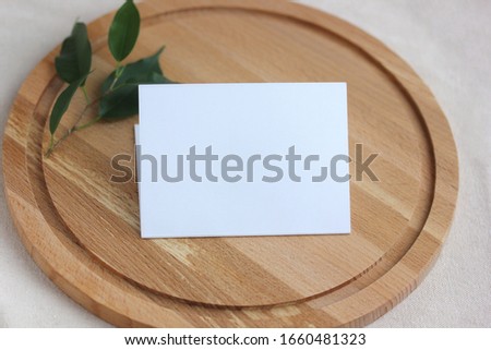mockup, template with an empty white cardboard postcard on a cutting Board. selective focus. space for Your text or image.