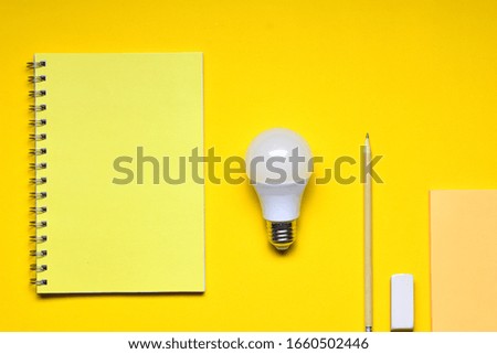 
Light bulb, ideas concept, writing material, on yellow background