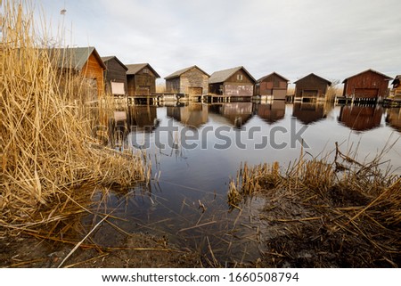 Neusiedler See, Lake Neusiedl. Bay with wooden pier and wooden cottage. Royalty-Free Stock Photo #1660508794