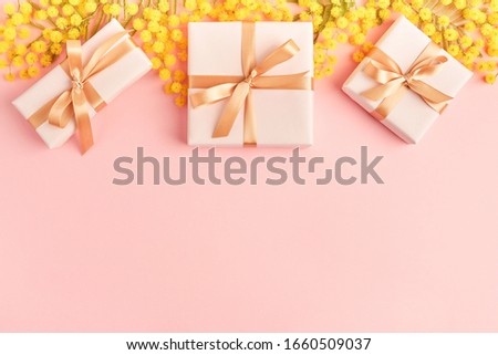 Spring flowers  mimosa with gift boxes on pink background, greeting card for Mothers Day, 8 March, Easter                                 