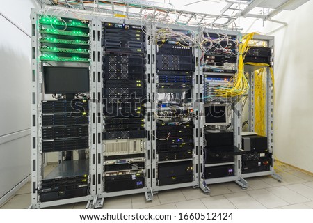 There are several racks with powerful computer equipment in the server room. Computing hardware works in a modern data center. Technical platform of the telecommunication Internet service provider