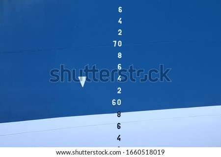 Waterline of a blue and white ship or boat. Depth finder lettering also in blue and white. Stylish nautical image.