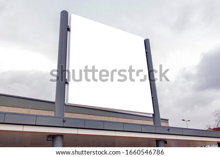 Mockup of the white blank square hanging logo sign in frame on the building wall or facade