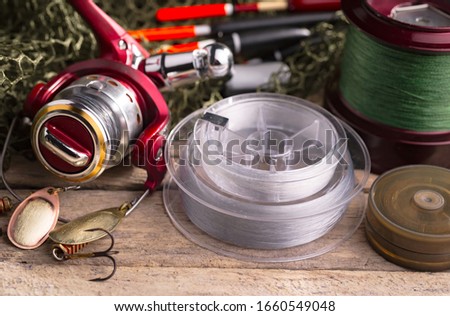 fishing tackle on a wooden table. Royalty-Free Stock Photo #1660549048