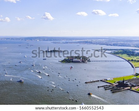 Boats on Hudson River near Ellis Island and New York in sunny day, aerial photography