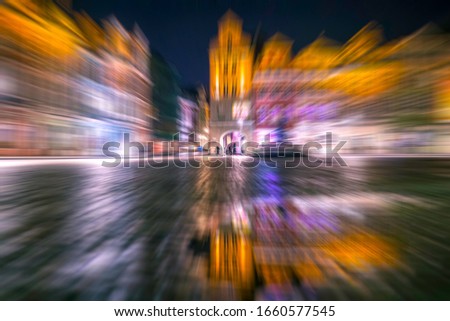 Old town by night, cityscape and colorful blurred lights of the Market Square (Stary Rynek), Poznan, Poland.
