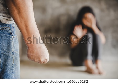 Woman scaring and protection of Man beating up, beaten and raped sitting in the corner ; violence concept Royalty-Free Stock Photo #1660585192