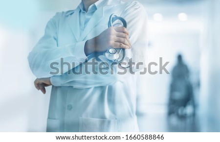 Healthcare and medical concept. Medicine doctor with stethoscope in hand and Patients come to the hospital background.