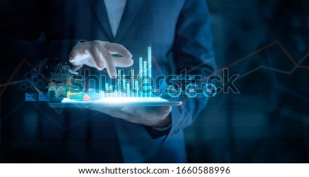 businessman using tablet analyzing and showing sales data business growth graph chart on virtual hologram with arrow up on global networking background, Digital marketing, Strategy and planning. 