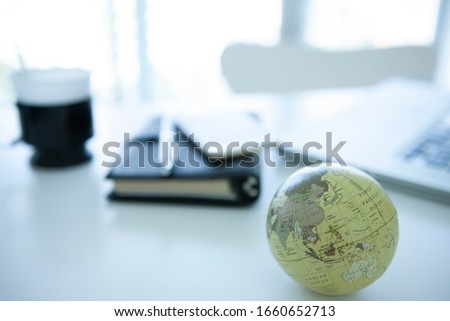 Globe and business goods on desk