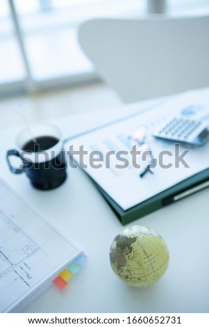 Globe and business goods on desk