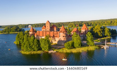 Beautiful aerial view photo from drone on Trakai Castle, located in the middle of Galve lake in Lithuania. Surrounded by beautiful lakes and green  islands with plenty of water attractions for tourist