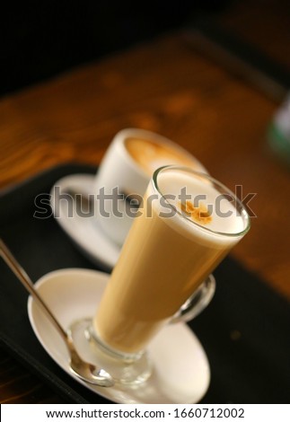 Photo of a large tasty cup of coffee with milk in a restaurant. Advertising coffee drink.
