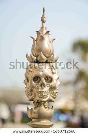 golden skull statue at Rung Khun Temple, Thailand, Chiang Rai, is a beautiful karma statue.