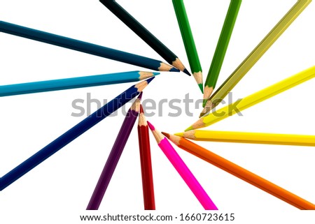 Color pencils make a circle on white background.
