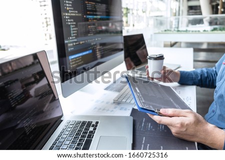Developer programmer working on project in software development computer in IT company office, Writing codes and data code website and coding database technologies to find solution to problem. Royalty-Free Stock Photo #1660725316