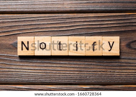 NOTIFY word written on wood block. NOTIFY text on wooden table for your desing, concept. Royalty-Free Stock Photo #1660728364