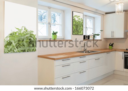 Vintage mansion - a white cooking area with pictures on walls