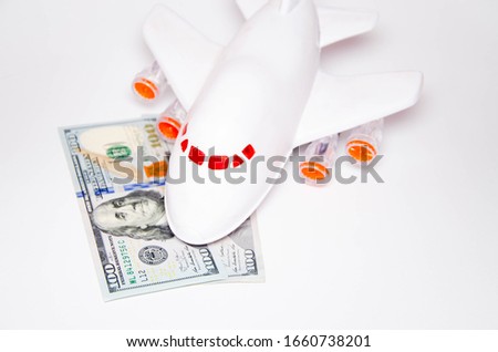 Airplane and dollars on a white background. Passenger airplane model on dollars and nearby. Business, air travel. Top and side view. Copy Space